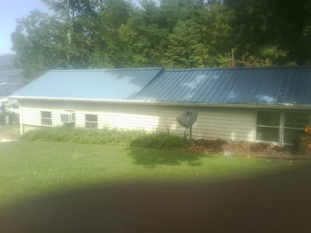 Blue metal roof running the length of a single story home in Dorchester